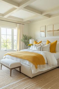 a bed with yellow and white pillows in a bedroom