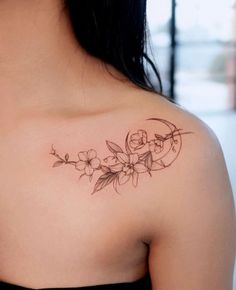 a woman with a flower tattoo on her shoulder