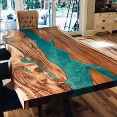 the table is made out of wood and has blue paint on it's surface