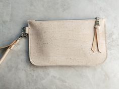 This dreamy white wristlet is giving us all the fashionista feels....how about you? A chic and eco-friendly wristlet made from eco-friendly cork leather is perfect for carrying your cash, cards and phone. Its useful keyring loop for attaching keys make for easier finding in your purse and a detachable wrist strap give you the option to use as a zip pouch inside your bag to keep small essentials organized. SMALL: 7 inches wide, 4.5 inches high LARGE: 8.5 inches wide, 5 inches high See more wristlet bundles and cork leather accessories here:  https://www.etsy.com/shop/hookandrope/?section_id=34318397 White Clutch Bag, Wristlet Pouch, White Clutch, Wristlet Purse, Wristlet Clutch, Leather Clutch Bags, Wristlet Wallet, Zip Wallet, Makeup Bags