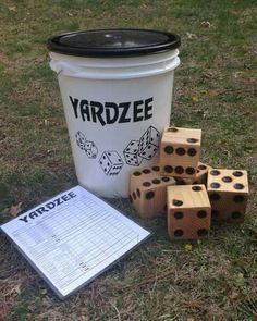 a bucket full of dices next to some paper on the ground