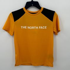 The North Face Boy's Never Stop Tee In Summit Gold Size Large New With Tags-Small Stain On Sleeve (See Picture, Washing Will Remove It) Please Feel Free To Ask Any Questions Before Purchasing Thank You! Yellow Sports T-shirt With Logo Print, Yellow Sporty T-shirt With Letter Print, Sporty Yellow T-shirt With Letter Print, Yellow Short Sleeve Tops For Outdoor, Yellow Sporty Top With Logo Print, The North Face Crew Neck Top With Letter Print, Black The North Face Crew Neck T-shirt, The North Face Black Crew Neck T-shirt, The North Face Letter Print Streetwear Tops