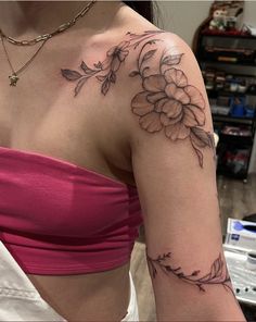 a woman with a flower tattoo on her arm