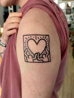 a man with a heart tattoo on his arm