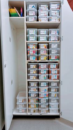 a white closet filled with lots of boxes and containers