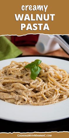 creamy walnut pasta on a white plate with basil garnish and text overlay