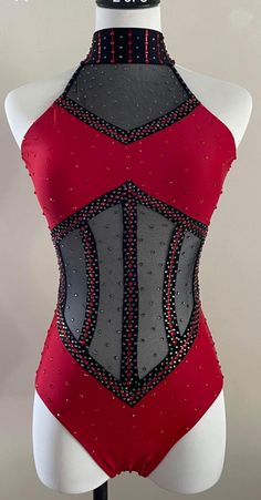 a mannequin wearing a red and black leotard