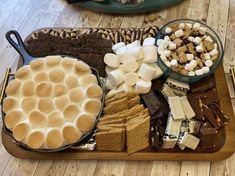 an assortment of desserts and marshmallows on a tray