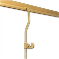 a gold coat rack with two hooks on it's sides and a white background