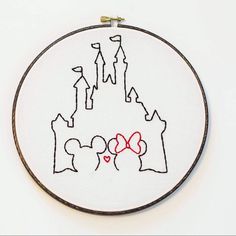 a cross stitch pattern with the shape of a castle and two hearts on it's side