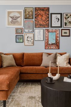 a living room filled with furniture and pictures on the wall