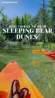 someone's feet on the edge of a kayak with trees in the background and text overlay that reads best things to do in sleeping bear dunes