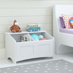 a child's toy storage unit with toys on it in a white room next to a bed