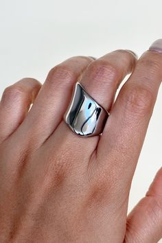 Put the spotlight on your unique style with this Exaggerated Glossy Signet Ring! You'll turn heads when you strut your stuff with this edgy and eye-catching statement piece. Featuring a glossy, oversized silver setting, you'll feel like an A-lister every time you slip it on! *wink* All of our jewelry comes with a free jewelry pouch and cloth to keep your pretties safe and clean. Details Color: Silver | Comes in GoldMaterial: Stainless SteelSizes: 6, 7, 8 Care Guide Store in a dry, cool place awa Chic Silver Open Ring Jewelry, Trendy Open Ring For Party, Chic Silver Rings For Everyday Wear, Minimalist Silver Rings For Party, Sleek Silver Rings With Polished Finish, Chic Everyday Silver Rings, Edgy Silver Open Ring Jewelry, Edgy Silver Metal Rings, Chic Silver Rings For Party