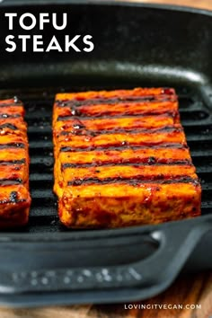 two tofu steaks cooking on a grill in a cast iron skillet with text overlay