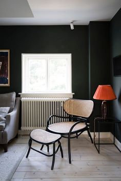 a living room filled with furniture and a lamp