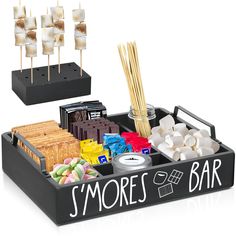 an assortment of sweets and marshmallows in a black tray that says s'mores bar