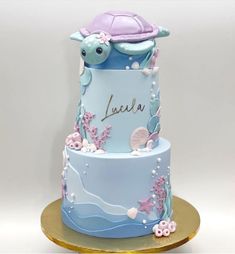 a blue and purple cake with a turtle on top