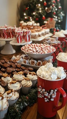 there are many desserts on the table with red mugs next to each other