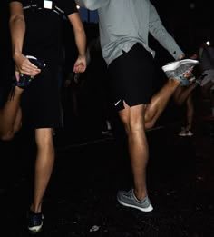 two people are playing frisbee in the dark