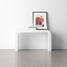 a white table with an art print on it