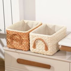 two baskets sitting on top of a dresser