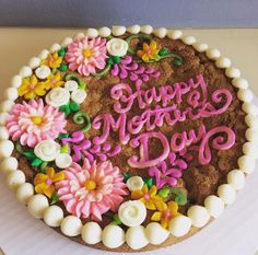 there is a cake with flowers on it that says happy mother's day written in frosting