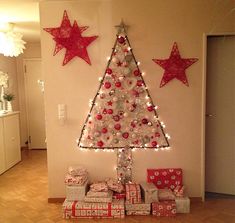 a christmas tree is decorated with lights and presents