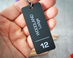 a person holding a black luggage tag in their hand