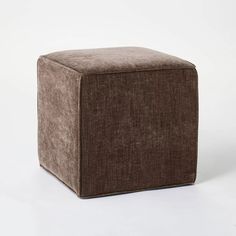 a square footstool with a brown fabric cover