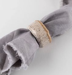 a close up of a napkin with a ring on it's end and a piece of fabric in the middle