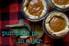 pumpkin pie in a jar on a table with leaves and autumn leaves around it text reads pumpkin pie in a jar