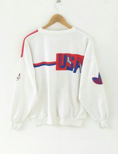 "PLEASE READ DESCRIPTIONS BEFORE BUYING. Contact me for any questions about this clothes. SUPERB RARE!! ADIDAS Olympic Sweatshirt 80s Sweater Pullover Crewneck Multicolour Vintage Usa Shirt Rap Tees Hip Hop Swag TAG BRAND:- ADIDAS SIZE ON TAG :- S ACTUAL SIZE MEASUREMENT :- ARM PIT TO ARM PIT :- 23\" inches BACK COLLAR TO HEM :- 26\" inches SLEEVE LENGHT : 21\" inches CONDITION :- good used condition // don't expect it to be like new or in pristine condition. Please read the description and poli Vintage Nike Sweater, Usa Sweatshirt, 80s Sweater, White Knit Sweater, Rap Tee, Nike Sweater, Usa Shirt, Nike Hoodie, Vintage Usa