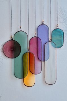 four colorful glass pieces hanging from strings