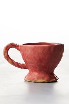 a red cup sitting on top of a white table