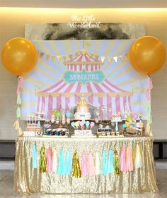 a circus themed dessert table with balloons