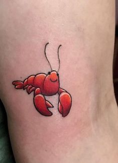 a small crab tattoo on the thigh