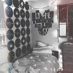 a bedroom decorated in black and white with records on the wall