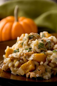 a close up of a plate of food with pumpkins in the background