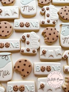 decorated cookies are arranged in the shape of baby's first milk bottle and cookies