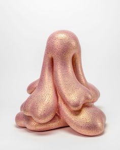 a pink sculpture sitting on top of a white floor