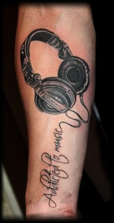 a man's arm with headphones on it and the words listen to music written in cursive writing