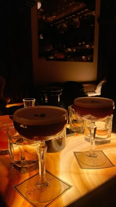 three wine glasses sitting on top of a table