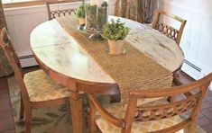 a wooden table with two vases on top of it and some chairs around it