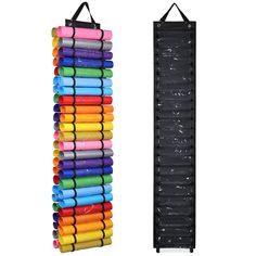 a rack that has many different colored pens on it and one is hanging from the wall