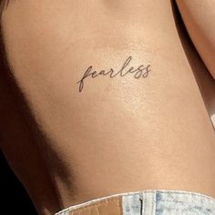 a woman's back with the word fearless written on it