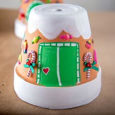 two cakes decorated with candy and candies are sitting on a table next to each other