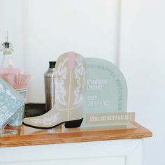 there is a cowboy boot and other items on the shelf next to the fireplace mantel