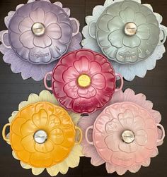 four flower shaped plates sitting on top of a table