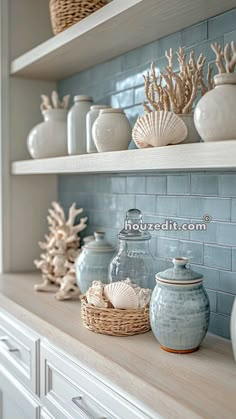 the shelves in this kitchen are filled with sea urns and seashells on them